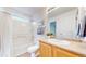 Well-maintained bathroom featuring a shower-tub combo, a vanity, and a large mirror at 11738 Zenobia Loop, Westminster, CO 80031