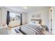Cozy bedroom with neutral color scheme, soft lighting, window, and comfortable furniture for a relaxing retreat at 11738 Zenobia Loop, Westminster, CO 80031