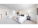Neutral bedroom features soft carpeting, a bed with decorative pillows, and ample natural light at 11738 Zenobia Loop, Westminster, CO 80031