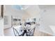 Dining area with modern table and chairs, connecting to a living room with high ceilings at 11738 Zenobia Loop, Westminster, CO 80031