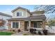 Charming two-story home featuring a stone facade, covered porch, and well-maintained landscaping at 11738 Zenobia Loop, Westminster, CO 80031