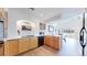 Well-lit kitchen featuring stainless steel appliances, light wood cabinets and plenty of counter space at 11738 Zenobia Loop, Westminster, CO 80031