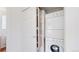 Laundry room with stackable washer and dryer and built in shelving for storage at 11738 Zenobia Loop, Westminster, CO 80031