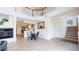 Spacious living room showcases a fireplace, dining area, staircase and open-concept kitchen with bar seating at 11738 Zenobia Loop, Westminster, CO 80031