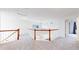 Open loft area showcasing light carpet, white walls, and decorative railings overlooking the living area below at 11738 Zenobia Loop, Westminster, CO 80031