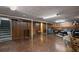 Finished basement has paneled walls and features a blue sofa with an ottoman at 3670 Ivanhoe St, Denver, CO 80207