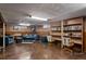 Basement den features blue seating, piano, a ceiling fan, and built-in bookshelves at 3670 Ivanhoe St, Denver, CO 80207