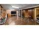 Large basement features a stairway, television, paneled walls, and a sitting area at 3670 Ivanhoe St, Denver, CO 80207