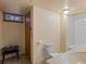 A cozy bathroom with a toilet, a sink, small window and a shower and bathtub combination at 3670 Ivanhoe St, Denver, CO 80207