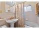 Traditional bathroom with pedestal sink, tub/shower combination, and tile flooring at 3670 Ivanhoe St, Denver, CO 80207