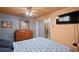 Bedroom with ensuite bath, ceiling fan, dresser, and wall-mounted television at 3670 Ivanhoe St, Denver, CO 80207