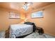 Comfortable bedroom with ceiling fan and natural light from two windows at 3670 Ivanhoe St, Denver, CO 80207