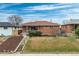 Charming brick home with a well-maintained lawn and landscaped front yard, creating great curb appeal at 3670 Ivanhoe St, Denver, CO 80207