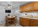 Cozy eat-in kitchen features a ceiling fan, dining table, and wood cabinetry at 3670 Ivanhoe St, Denver, CO 80207
