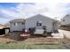 Cozy backyard with a fire pit, rock patio, and mature trees at 8441 Mcdougal St, Denver, CO 80229