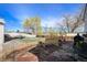 Spacious backyard with a mix of patio, wood mulch, and green lawn at 8441 Mcdougal St, Denver, CO 80229