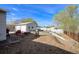 Backyard with rock patio area, detached garage, and lush lawn at 8441 Mcdougal St, Denver, CO 80229