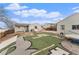 Spacious backyard with a detached garage and custom turf design creating a fun outdoor space at 8441 Mcdougal St, Denver, CO 80229