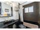 Unique bathroom boasts black and gold geometric wallpaper, accented by sleek black fixtures at 8441 Mcdougal St, Denver, CO 80229