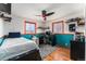 Comfortable bedroom featuring hardwood floors, creative decor, and large windows for natural lighting at 8441 Mcdougal St, Denver, CO 80229