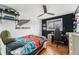 This bedroom features hardwood floors and black accent wall and built in storage shelves at 8441 Mcdougal St, Denver, CO 80229