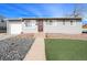 Charming single-story home with gray siding, updated windows, well-maintained landscaping, and a red front door at 8441 Mcdougal St, Denver, CO 80229