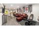 Basement living room with movie posters, a wet bar, leather furniture, and a workout area at 8441 Mcdougal St, Denver, CO 80229
