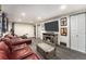 Comfortable Gathering room with leather sofas, an electric fireplace, and a large TV screen at 8441 Mcdougal St, Denver, CO 80229
