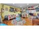 Bright living room featuring vibrant decor, hardwood floors, and a seamless transition to the adjacent kitchen at 8441 Mcdougal St, Denver, CO 80229