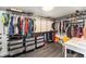 Spacious walk-in closet with custom storage, wood-look floors, and a bright light fixture at 8441 Mcdougal St, Denver, CO 80229