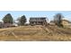 Exterior of home with a large backyard and a spacious deck at 7729 Beverly Blvd, Castle Pines, CO 80108