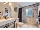 Modern bathroom featuring new fixtures, tiled shower, toilet, and a modern sink at 7729 Beverly Blvd, Castle Pines, CO 80108