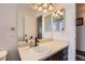 Bathroom vanity with framed mirror, modern faucet, and decorative vanity lighting at 7729 Beverly Blvd, Castle Pines, CO 80108