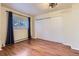 Bright bedroom with hardwood floors, a closet, and a large window at 7729 Beverly Blvd, Castle Pines, CO 80108