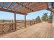 Expansive wood deck with pergola overlooking city and mountain views at 7729 Beverly Blvd, Castle Pines, CO 80108