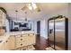Open concept kitchen and living room featuring stainless steel appliances and hardwood floors at 7729 Beverly Blvd, Castle Pines, CO 80108