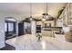 Modern kitchen with stainless steel appliances, marble countertops, and stylish pendant lighting at 7729 Beverly Blvd, Castle Pines, CO 80108