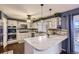 Bright kitchen with marble countertops, stainless steel appliances, and white cabinetry at 7729 Beverly Blvd, Castle Pines, CO 80108