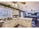 Open kitchen design with white marble countertops, stainless steel sink, and hardwood floors at 7729 Beverly Blvd, Castle Pines, CO 80108