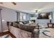 Spacious living room with a fireplace, a large television, and a comfortable sofa at 7729 Beverly Blvd, Castle Pines, CO 80108