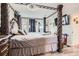 Spacious main bedroom featuring a four-poster bed, hardwood floors, and soft neutral decor at 7729 Beverly Blvd, Castle Pines, CO 80108