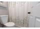 Clean bathroom with toilet and modern leaf-patterned shower curtain at 16301 Hudson Rd, Hudson, CO 80642