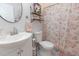 Charming bathroom features floral shower curtain, round mirror and shelf decor at 16301 Hudson Rd, Hudson, CO 80642