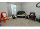 A charming Bedroom with a crib, chair, toys, and a window with view of the outdoors at 16301 Hudson Rd, Hudson, CO 80642