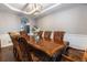 Elegant dining room featuring a large table, decorative chairs, and a stylish light fixture at 16301 Hudson Rd, Hudson, CO 80642
