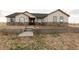 Charming ranch-style home featuring a stone facade and a well-maintained front yard at 16301 Hudson Rd, Hudson, CO 80642