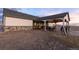 An exterior view shows a single-story home with a covered patio and a spacious yard at 16301 Hudson Rd, Hudson, CO 80642
