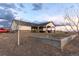 Exterior angle of the home with a covered patio, showing the surrounding expansive lot with trees at 16301 Hudson Rd, Hudson, CO 80642