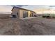Detached two car garage with concrete apron, tractor and other equipment in the back yard at 16301 Hudson Rd, Hudson, CO 80642