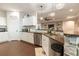 Modern kitchen featuring stainless steel appliances, granite counters, and white cabinetry at 16301 Hudson Rd, Hudson, CO 80642